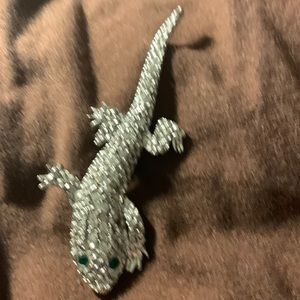 Silver-tone metal rhinestone lizard.